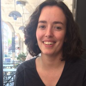 Woman with short brown hair sitting in a cafe